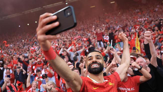 Mohamed Salah of Liverpool takes a selfie with the fan. Photo by Carl Recine/Getty Images.