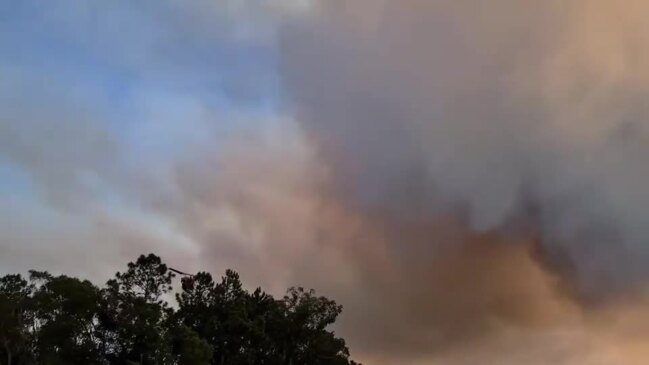 Firefighting helicopter drops water on Beerwah bushfire