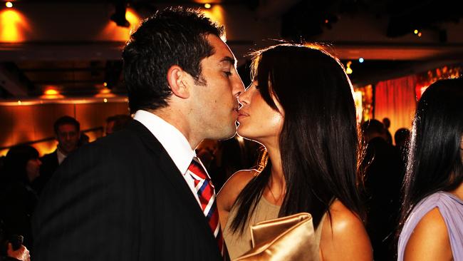 The couple share a kiss at the 2010 NRL Grand Final breakfast. Picture: Christian Wright