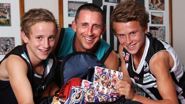 Port Adelaide Best and Fairest Darren Mead with his sons Jackson 12yrs and Mitchell 14yrs with the AFL footy cards. PIC SARAH REED