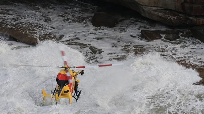 The Westpac Rescue helicopter searches for the missing man. Picture: Toby Zerna