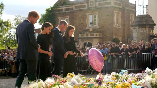 The foursome view floral tributes left at Windsor Castle. Picture: WPA Pool/Getty Images