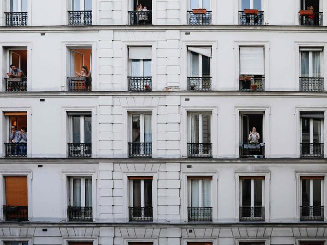 People take part in a daily 8 o'clock applause in support of medical workers in France. Picture: AFP