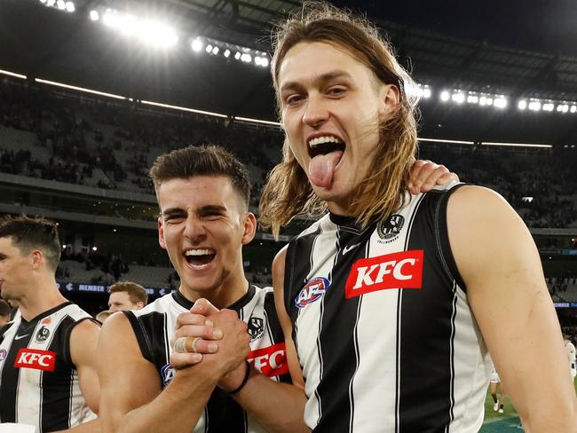 MELBOURNE, AUSTRALIA - AUGUST 21: Nick Daicos of the Magpies and Darcy Moore of the Magpies celebrate during the 2022 AFL Round 23 match between the Carlton Blues and the Collingwood Magpies at the Melbourne Cricket Ground on August 21, 2022 in Melbourne, Australia. (Photo by Dylan Burns/AFL Photos via Getty Images)