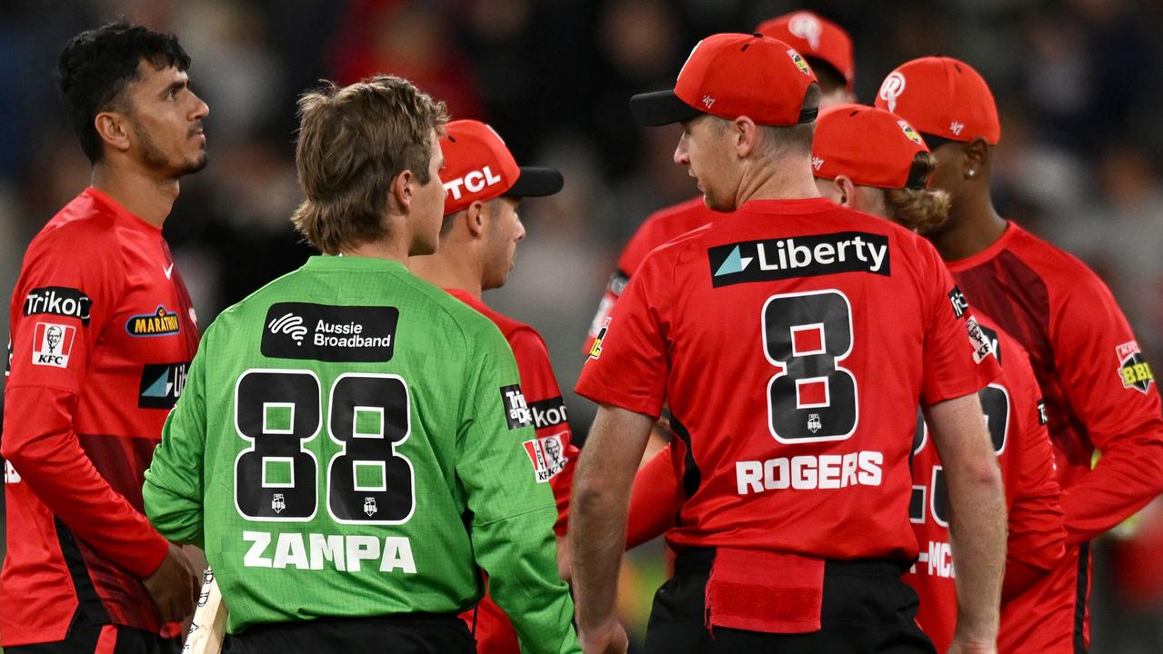 Tom Rogers and Adam Zampa come together after the game. Picture: Morgan Hancock / Getty Images