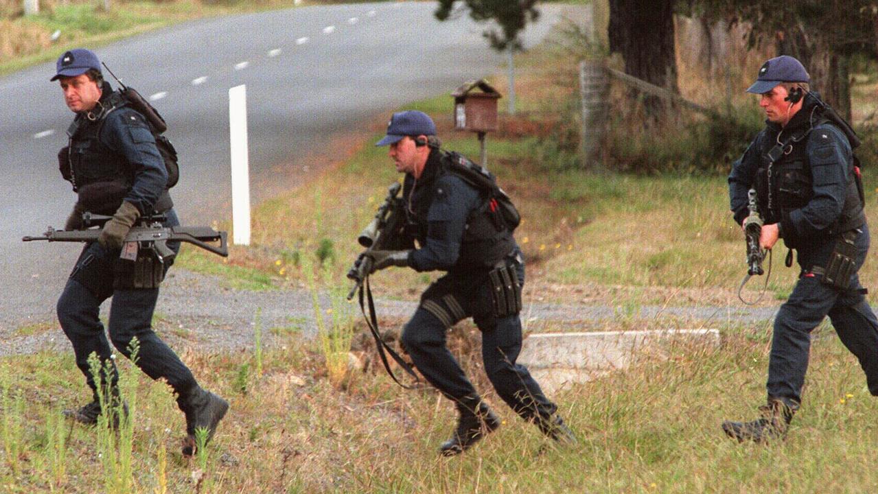 Heavily armed members of police Special Operations Group take up positions around Seascape Cottage where Bryant holed up after his Port Arthur rampage.