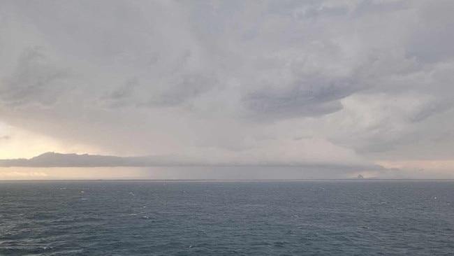 Storm over the Glass House Mountains from Moreton Bay. Photo: Matt