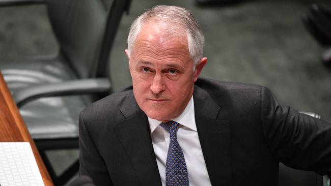 The Prime Minister posted a candid snap cradling his one-year-old granddaughter Alice at the AFL while holding a beer in the other hand. Picture: AAP