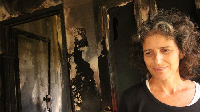 Kathy assesses fire and flood damage in her Mullumbimby home. Picture: Mo McMorrow