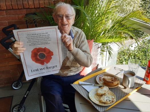 Bruce Scott, 97, who served in WWII in New Guinea and is one of only three remaining men from his unit. Bruce still lives at home in Greenwich Anzac Day has always been special for him. Pictured with The Daily Telegraph poppy poster.