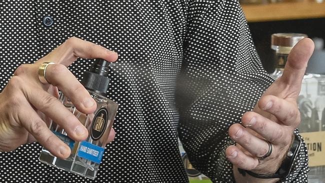 SA brand Prohibition Liquor Co is making hand sanitiser in the wake of the coronavirus outbreak. Adam Carpenter pictured using the hand sanitiser. Picture: Roy VanDerVegt