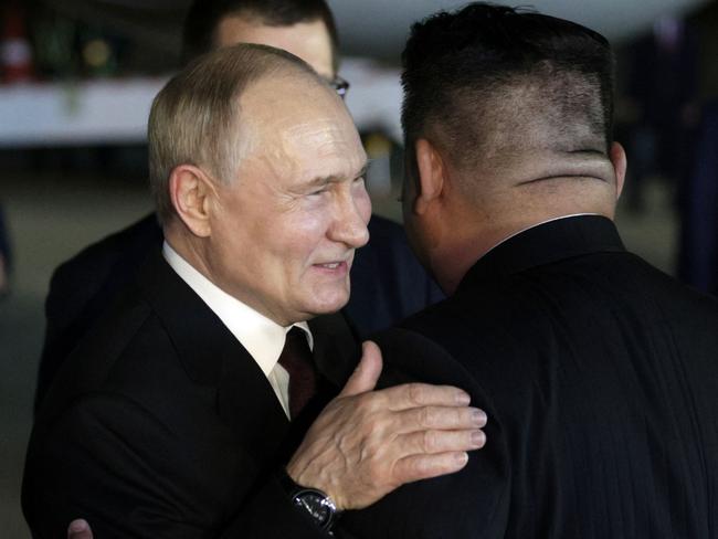 Vladimir Putin embraces Kim Jong-un after touching down in Pyongyang. Picture: AFP