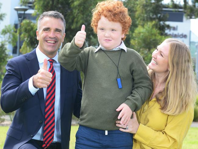 Sami Glastonbury with son Frank, 8 and Labor Leader Peter Malinauskas near the site of the new WCH on Port Road, Adelaide on Monday 21st February 2022 - Picture: Michael Marschall