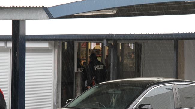 Police enter Coles in Alice Springs. Picture: Gera Kazakov