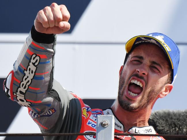 Ducati Team's Italian rider Andrea Dovizioso celebrates victory on podium of the MotoGP race of the San Marino Grand Prix at the Marco Simoncelli Circuit in Misano on September 9, 2018. (Photo by Tiziana FABI / AFP)