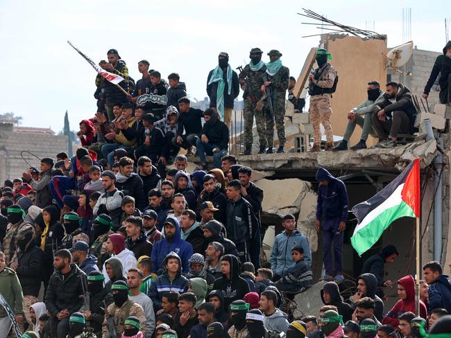 Palestinian Hamas militants and people gather at the site of the handing over of the bodies of four Israeli hostages in Khan Yunis in the southern Gaza on February 20, 2025. Picture: AFP