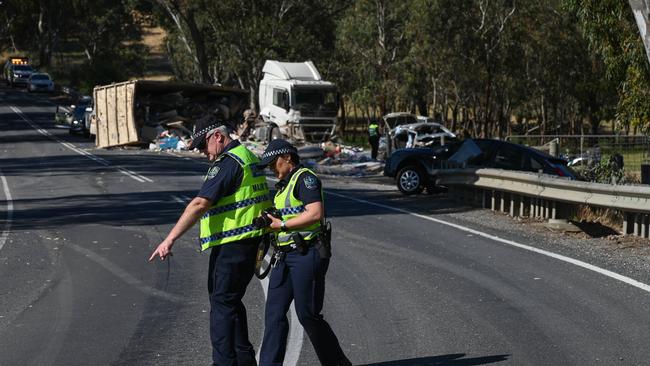 Major Crash officers examine the road. Picture: Naomi Jellicoe