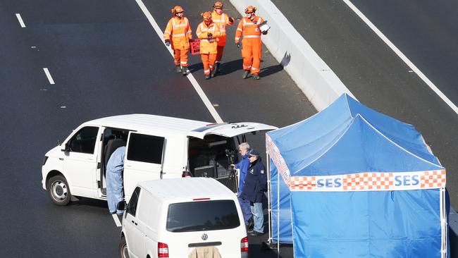 Police and emergency services investigate a shooting on the Eastern freeway. Picture: David Crosling