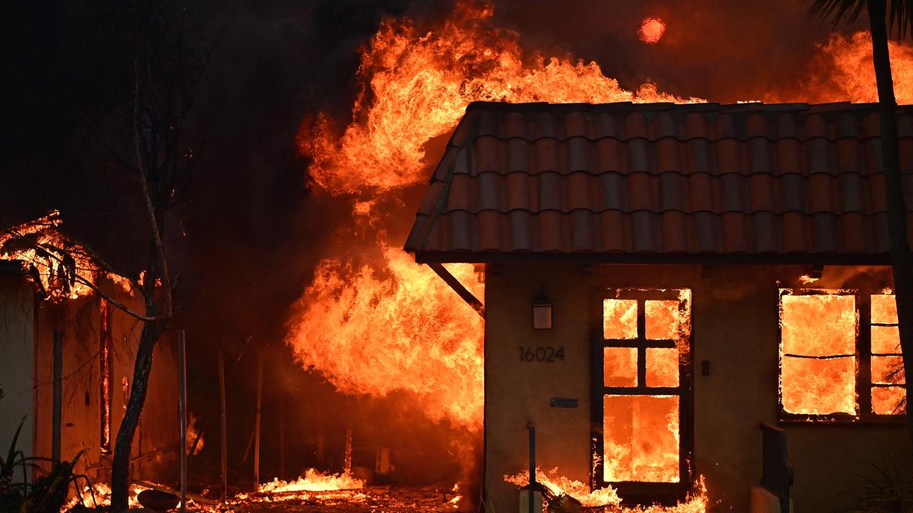 A home burns during the Palisades Fire in Pacific Palisades, California. (Photo by AGUSTIN PAULLIER / AFP)