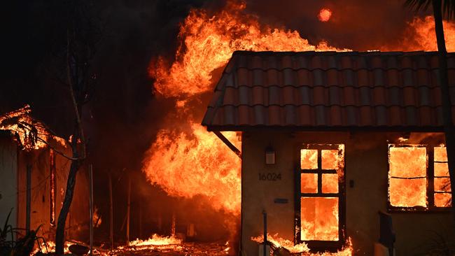 A home burns during the Palisades Fire in Pacific Palisades, California. (Photo by AGUSTIN PAULLIER / AFP)