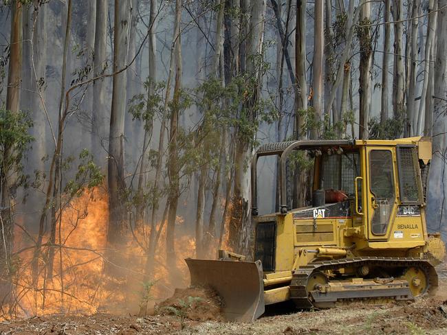 High country bushfires. DSE and CFA crews backburning (doing asset protection) on a private property just off the Mansfield-Whitfield Road, about 15 kms south of Whitfield and 4kms from the fire front. A D4 bulldozer driven by DSE worker Bart Berry making the firebreak.