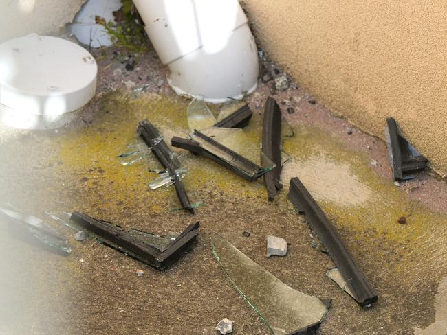 Broken glass under a window at the mausoleum. Picture: Andrew Henshaw