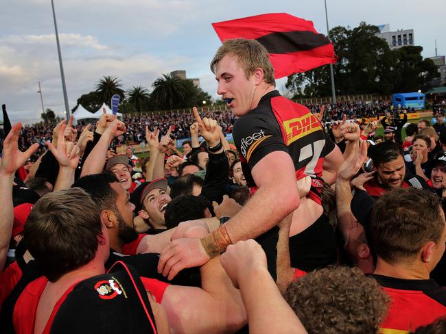 Captain Will Miller is hoisted high after Norths broke their 41-year duck. Picture: Troy Snook