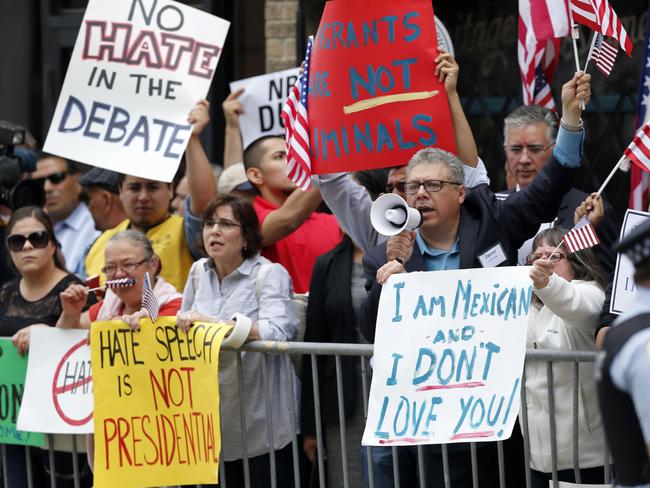 Anger ... Protesters gather across the street from a restaurant in Chicago on Monday before Republican presidential candidate Donald Trump spoke to members of the City Club of Chicago. Picture: Charles Rex Arbogast/AP