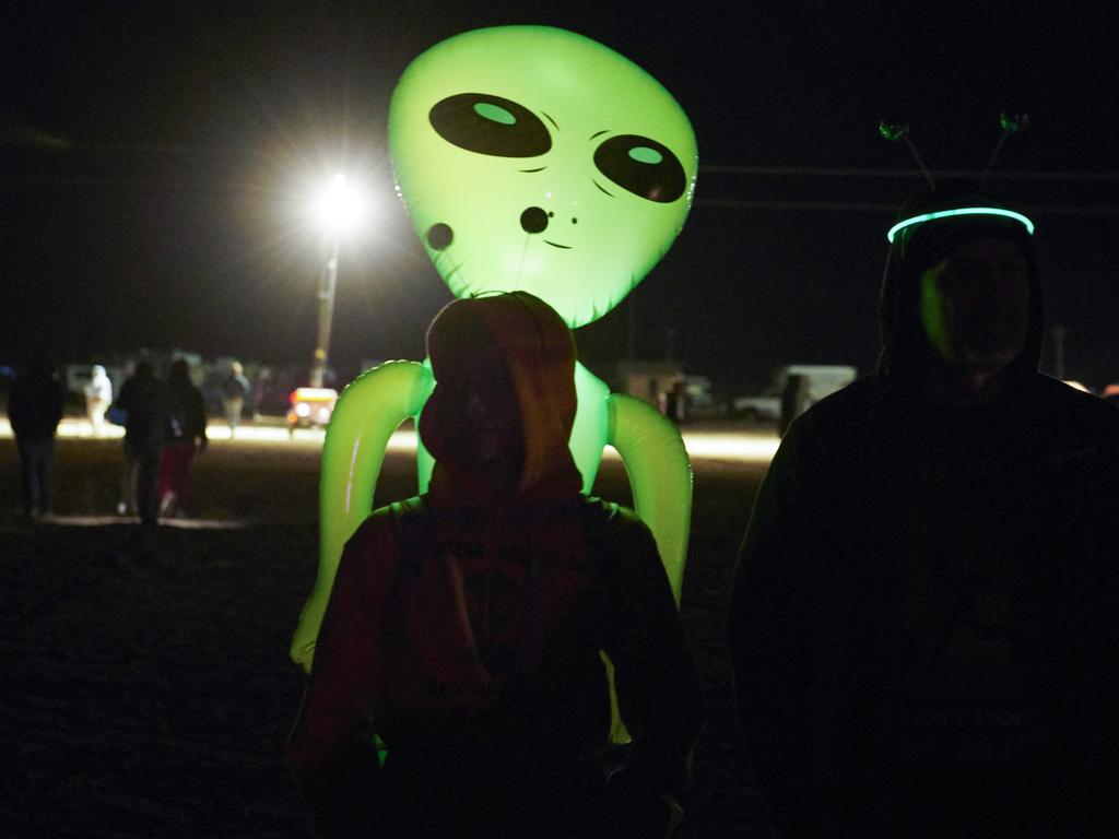 A small group of alien-hunters gather to "storm" Area 51 at an entrance to the military facility. Picture: Bridget BENNETT / AFP