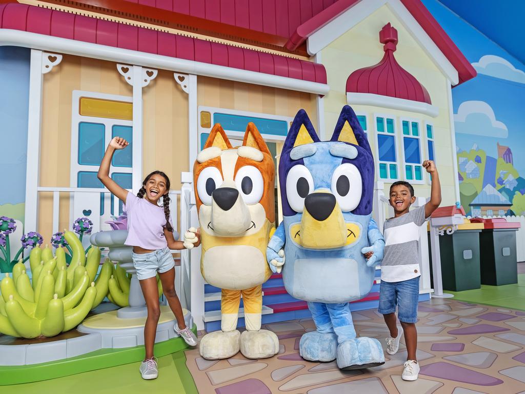 Bluey's World Brisbane will be open throughout the school holidays. Pictured: Madeleine Evans, 10, and Joshua Evans, 7, with Bingo and Bluey.