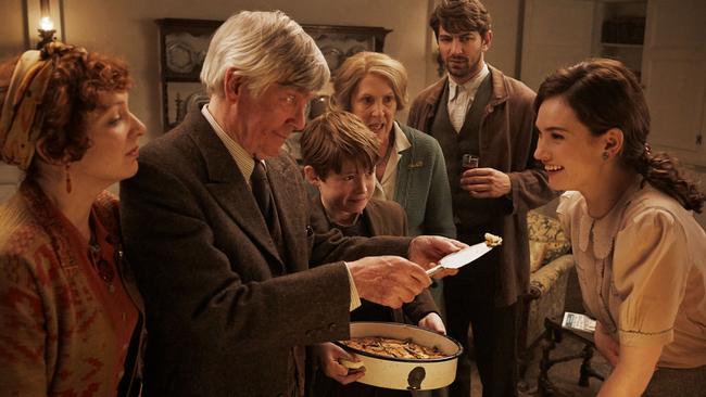 L-R: Katherine Parkinson, Tom Courtenay, Kit Connor, Penelope Wilton, Michiel Huisman and Lily James in a scene from film The Guernsey Literary and Potato Peel Pie Society