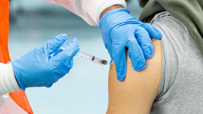 (man receives a dose of the Moderna vaccine at a vaccination site in the Bronx New York. Picture: AFP.