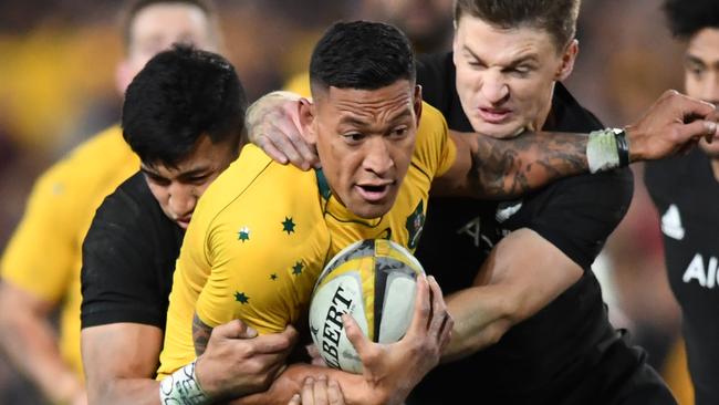 Folau of Australia is tackled by Rieko Ioane and Beauden Barrett. (AAP Image/David Moir)