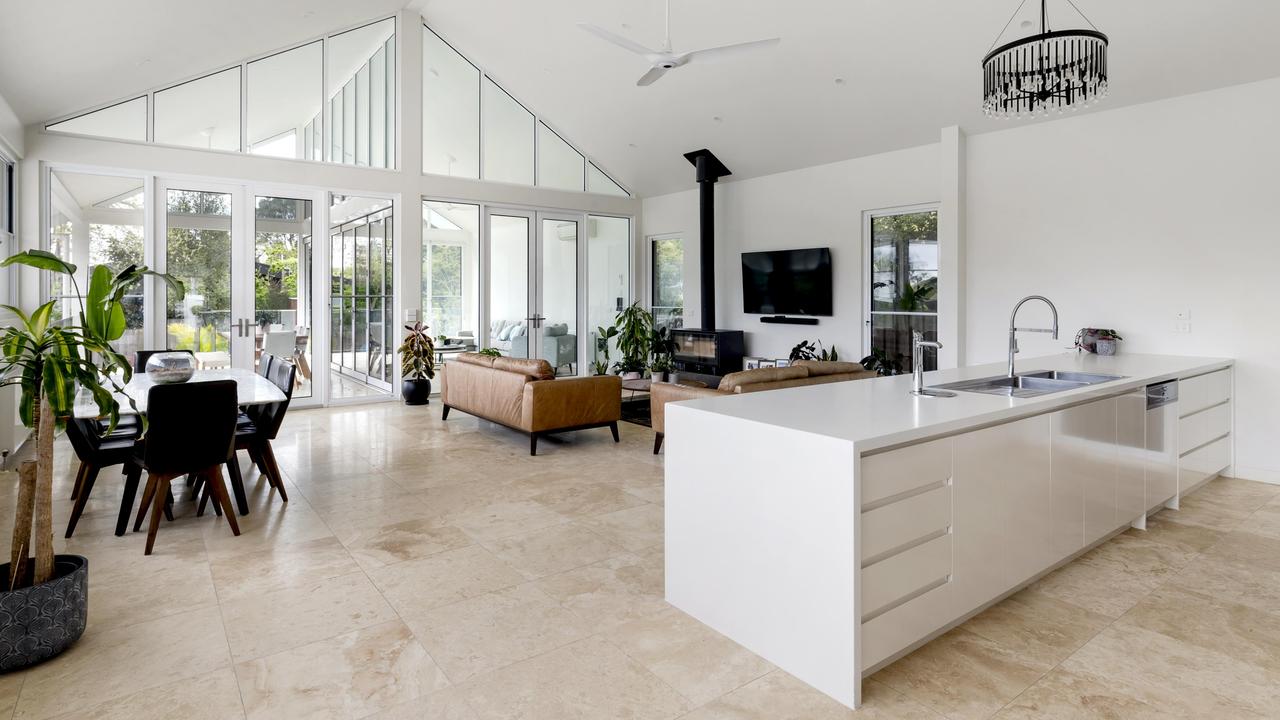 The kitchen and a stone island bench.