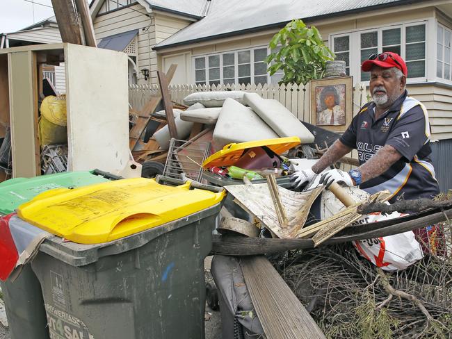 Adrian Coolwell cleans up after the Brisbane floods. Picture: NCA NewsWire/Tertius Pickard