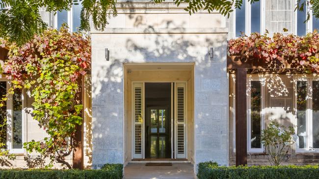 The Georgian-inspired facade includes a portico entrance.