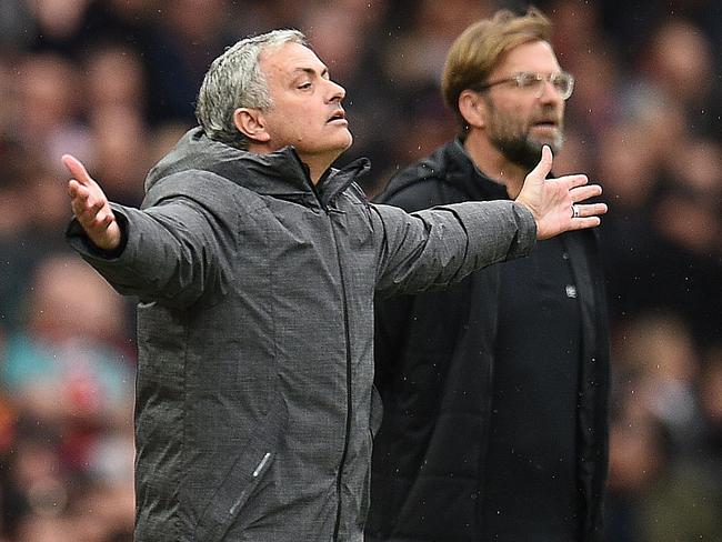 Jose Mourinho (L) with Liverpool’s Jurgen Klopp.