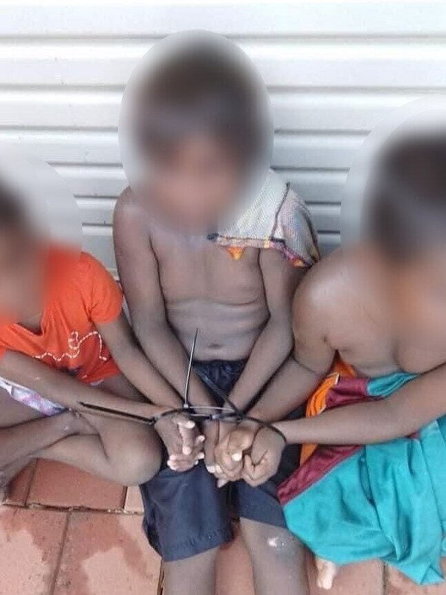 Three Aboriginal children tied up with cable ties in a front yard. Picture: Instagram