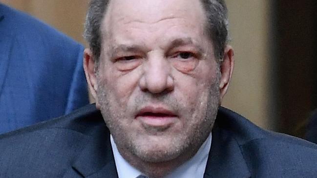 (FILES) In this file photo taken on February 20, 2020, Harvey Weinstein (C) uses a walker as he leaves Manhattan Criminal Court after the third day of jury deliberations in his sex crimes trial in New York. - Weinstein pleaded not guilty in a courtroom in Los Angeles on July 21, 2021, to all 11 charges of rape and sexual assault against five women in California hotel rooms. The convicted rapist who is already serving 23 years has been brought back to the city where he once presided over massive, industry-shaking film deals to face more charges that could result in an additional 140 years in prison. (Photo by Angela Weiss / AFP)