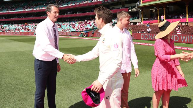 Glenn McGrath receives the baggy pink caps from Tim Paine and the Australian team on Jane McGrath day at the SCG. Picture: Phil Hillyard