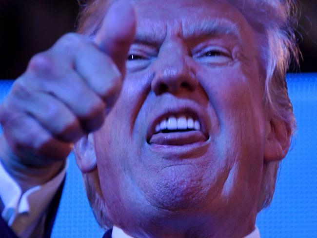 US Republican presidential candidate Donald Trump greets delegates on day three of the Republican National Convention at the Quicken Loans Arena in Cleveland, Ohio, on July 20, 2016. / AFP PHOTO / Jim WATSON