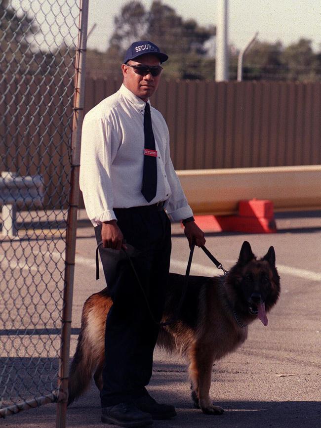 A Security guard patrols Port Botany wharf with a guard dog in 1998.