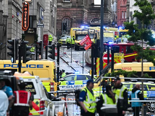 Ambulances and police vans arrive on the scene of the incident in Water Street. Picture: AFP