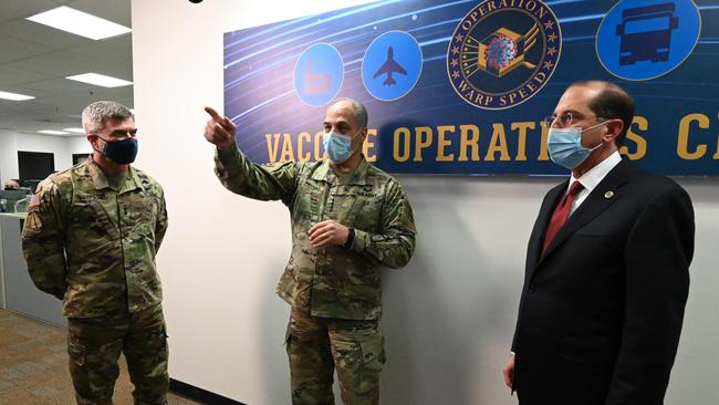 US Health and Human Services Secretary Alex Azar (R) and General Gus Perna (C) visiting the Operation Warp Speed Vaccine Operation Center (VOC) in Washignton, DC. Picture: AFP