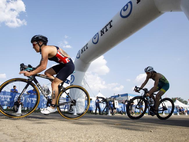 Britain's Jodie Stimpson, followed by Ashleigh Gentle (17), of Australia, as they turn the corner while riding the bike during the women's elite race at the ITU World Triathlon Series in Edmonton, Alberta, Friday, July 27, 2018. (Jason Franson/The Canadian Press via AP)