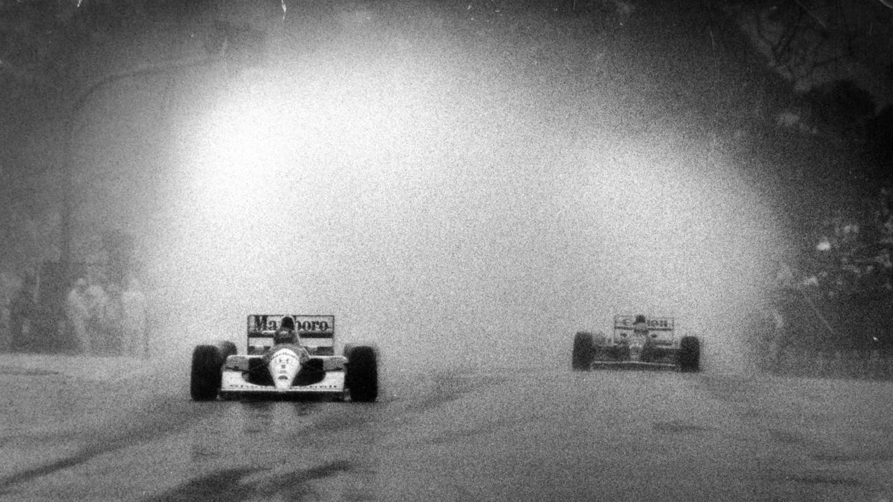 McLaren’s Ayrton Senna leads Williams rival Nigel Mansell on his way to victory at the infamous 1991 Adelaide downpour. Picture: Ray Titus