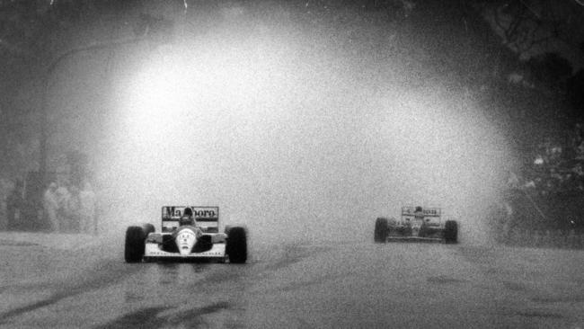 McLaren’s Ayrton Senna leads Williams rival Nigel Mansell on his way to victory at the infamous 1991 Adelaide downpour. Picture: Ray Titus