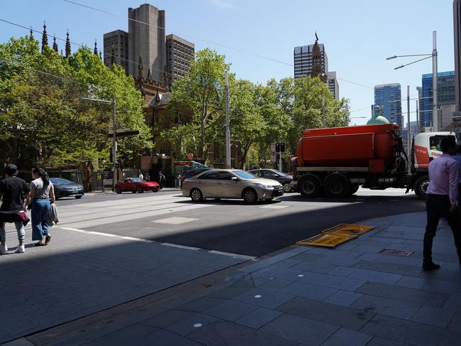 Cars parked across tram tracks on George St.