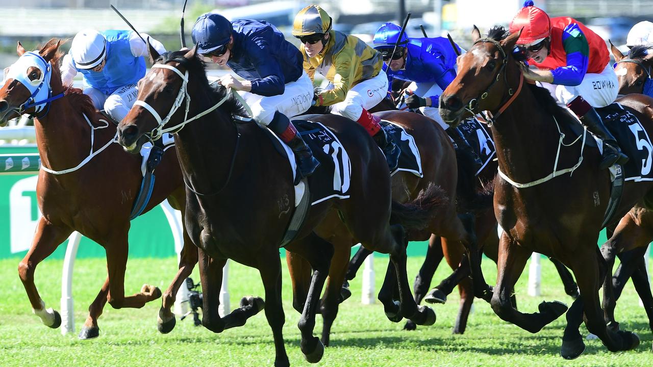 Political Debate (navy blue) holds off Sharp 'N' Smart (outside, red and blue) to win The Phoenix at Eagle Farm. Picture: Grant Peters - Trackside Photography.