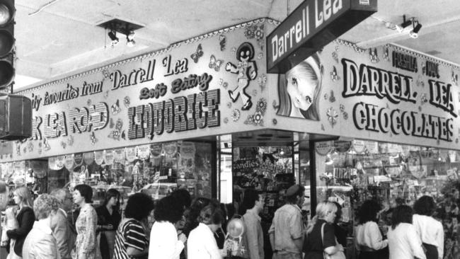 People outside the Darrell Lea store on the corner of Russell and Bourke St.